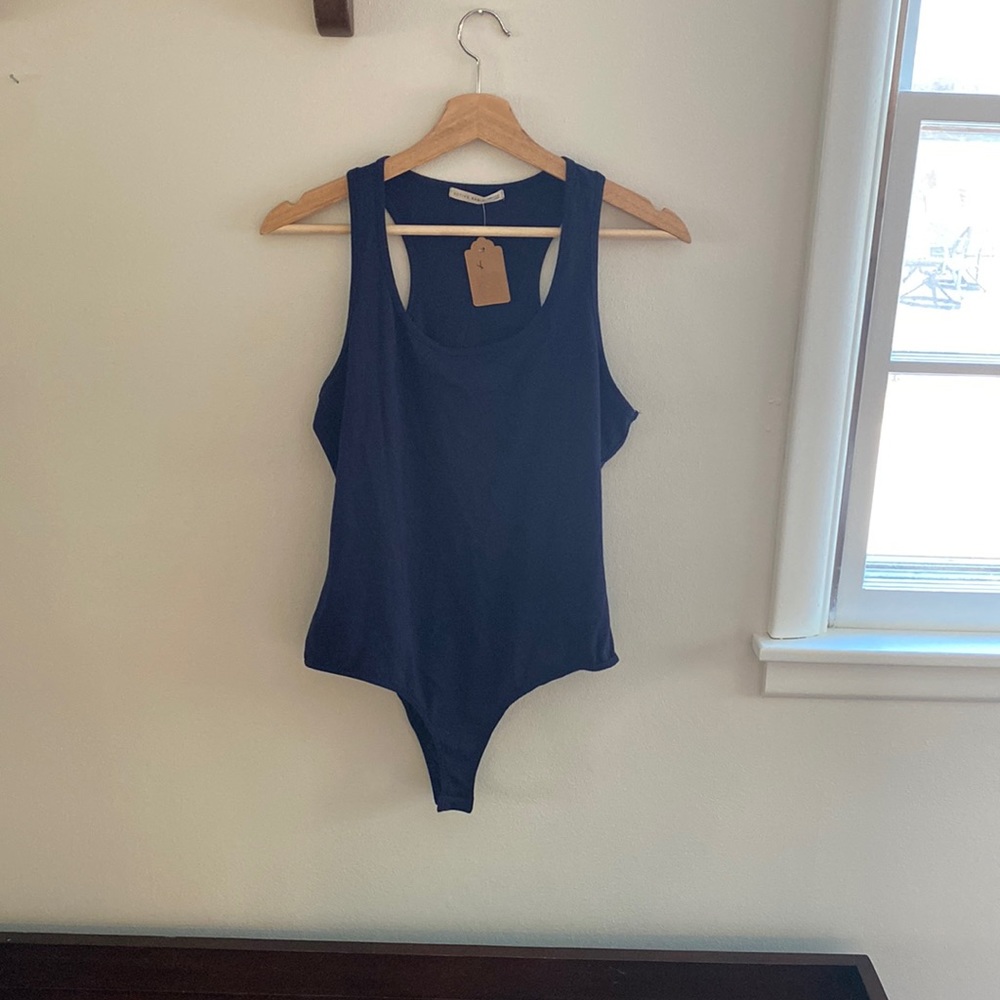 NWT. Navy blue racer back snap bodysuit fits size medium